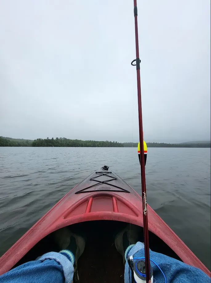 Feet in a kayak on a misty morning